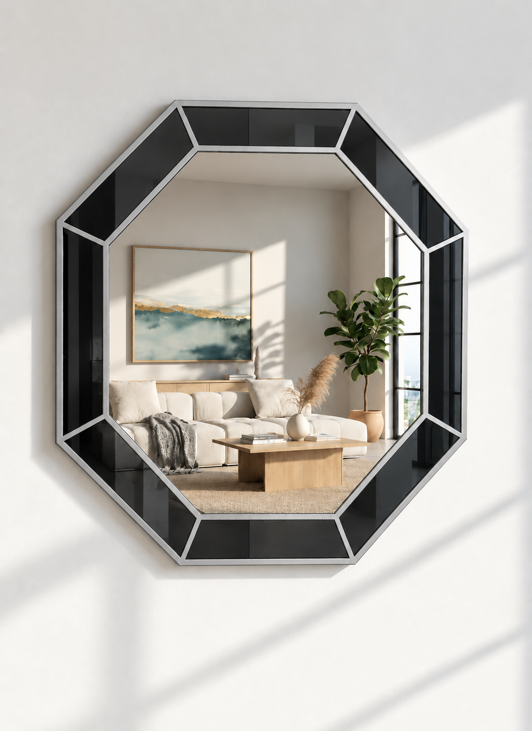An octagonal wall mirror with a glossy black frame and silver geometric dividers, mounted on a white wall. The mirror reflects a modern living room interior with a beige sofa, wooden coffee table, and a potted green plant.