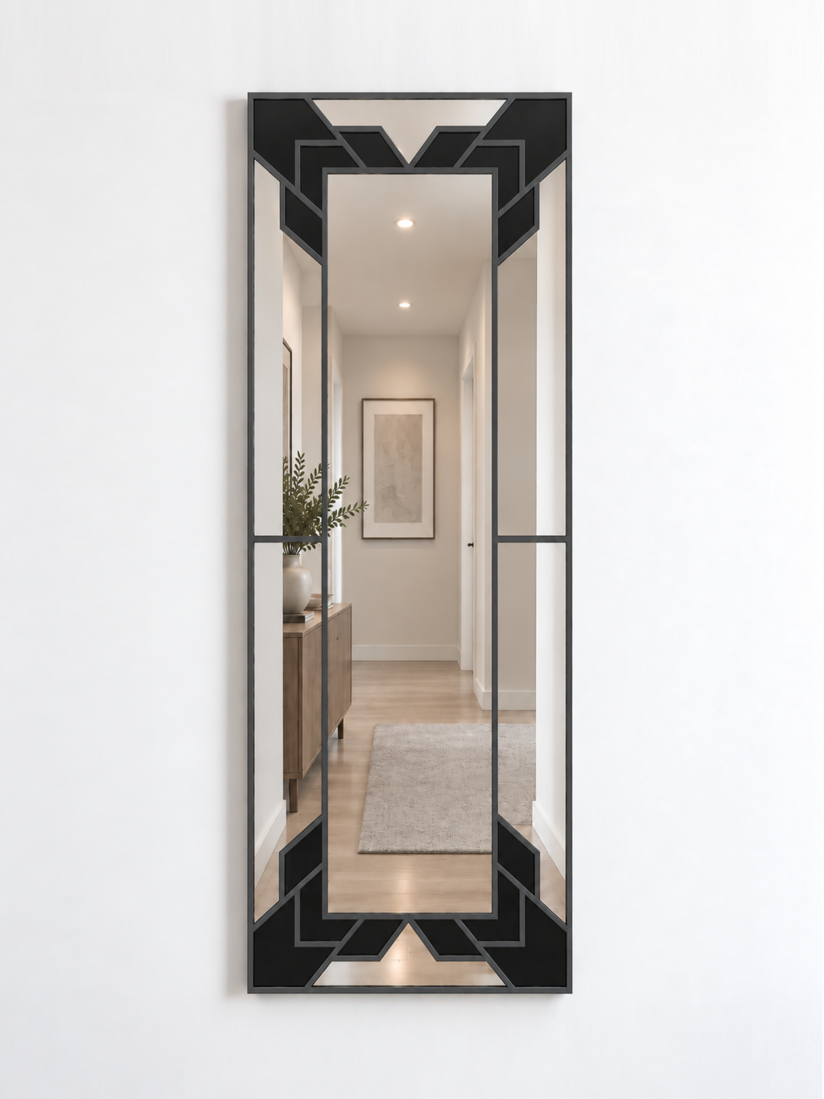 A slim rectangular geometric/art deco wall mirror with an antique frame and black sections