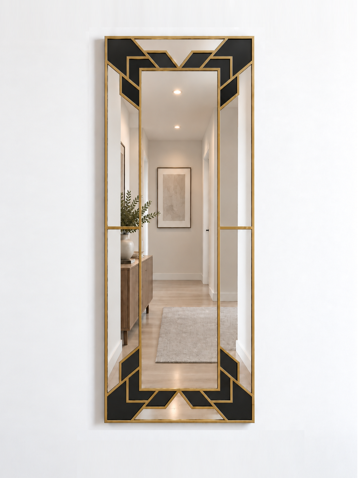 A slim rectangular geometric/art deco wall mirror with a brass frame and black sections