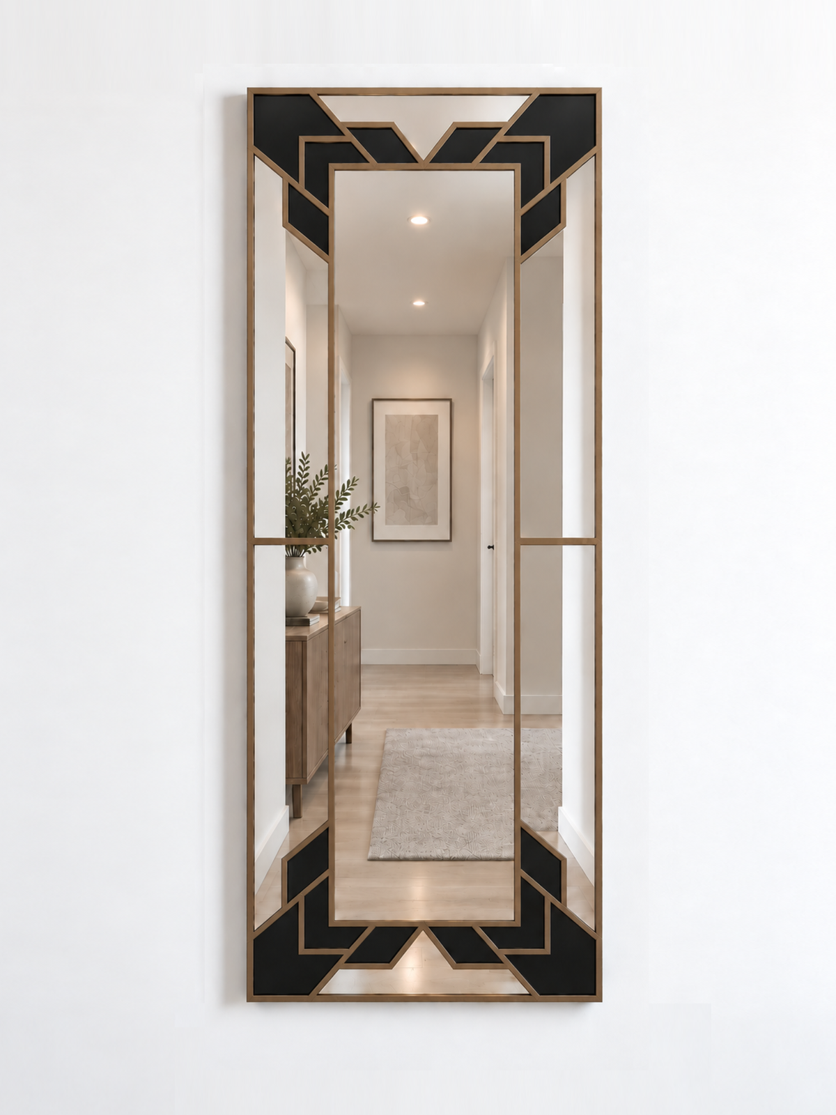 A slim rectangular geometric/art deco wall mirror with a gold frame and black sections