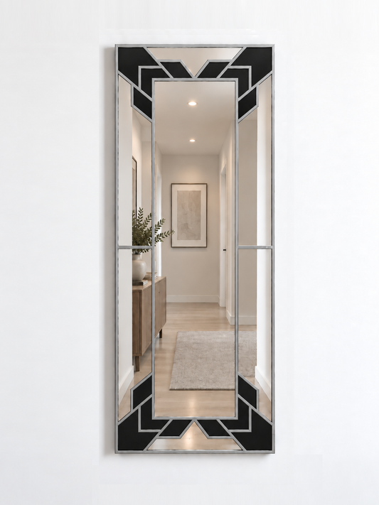 A slim rectangular geometric/art deco wall mirror with a silver frame and black sections