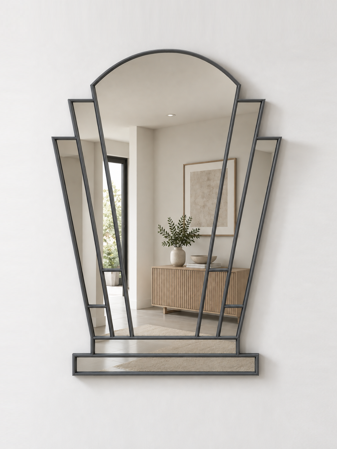 An antique-framed geometric wall mirror with an arched top and multiple angled panels, mounted on a white wall.
