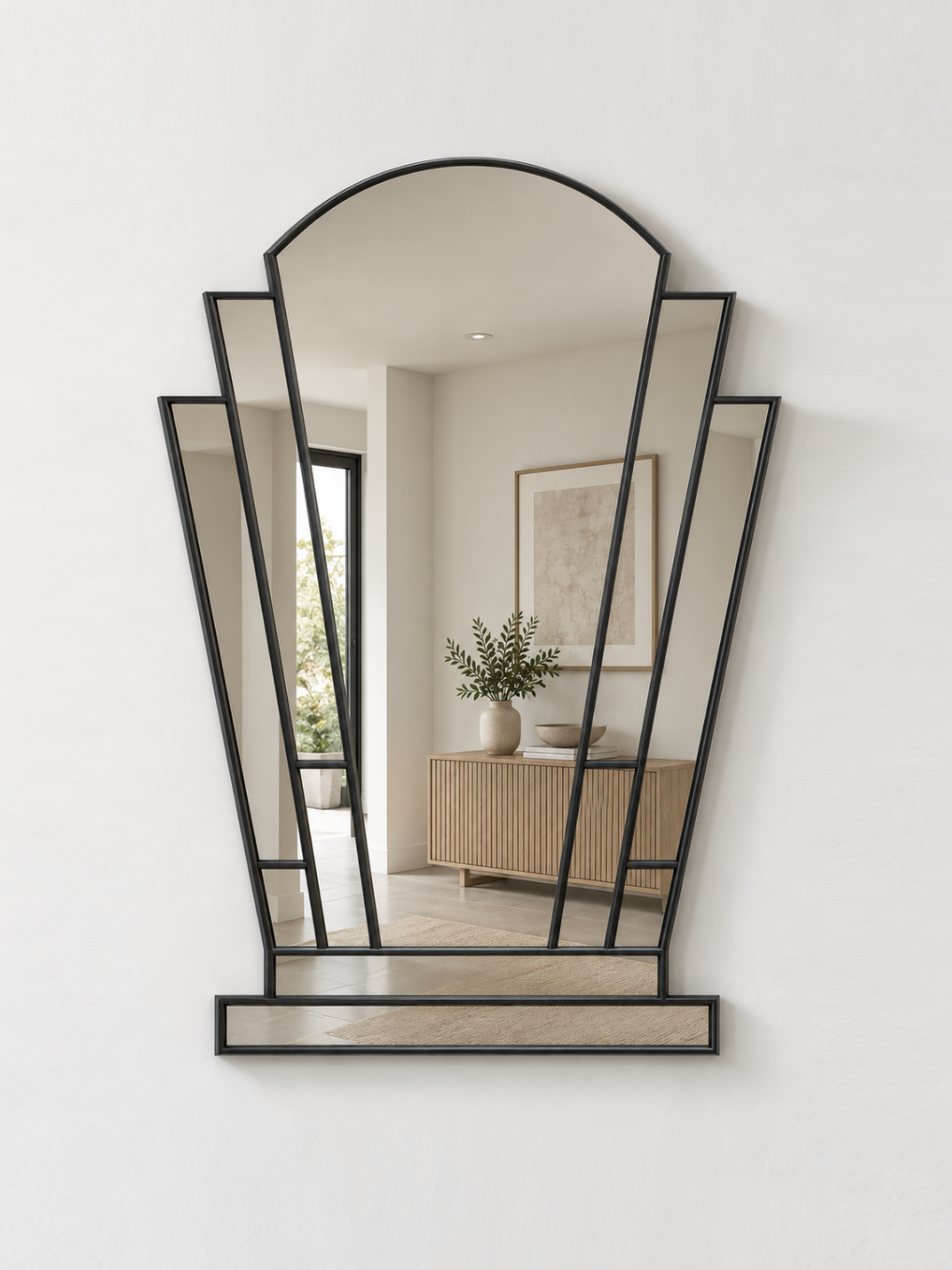 A black-framed geometric wall mirror with an arched top and multiple angled panels, mounted on a white wall.
