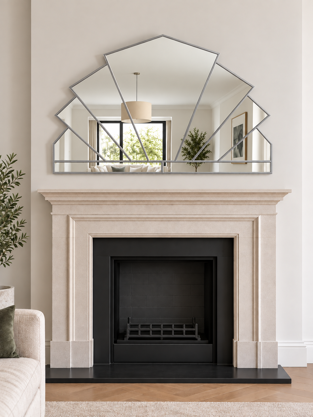 A large geometric overmantle mirror in silver