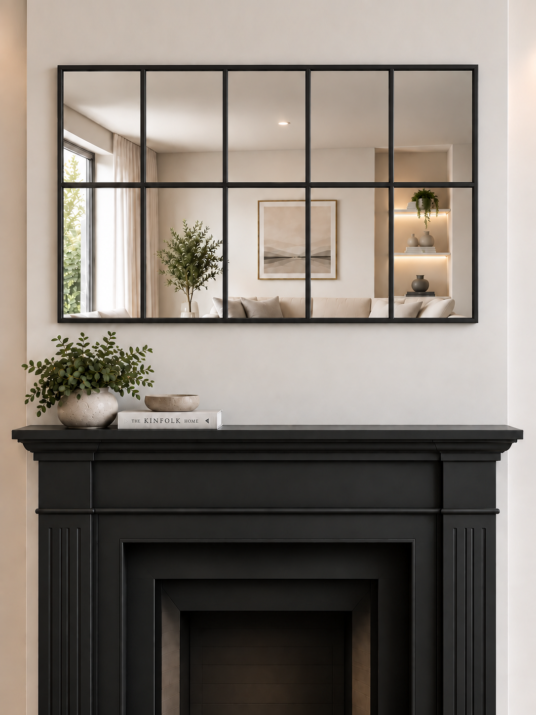 A large rectangular wall mirror with a black metal grid frame hangs above a black fireplace 