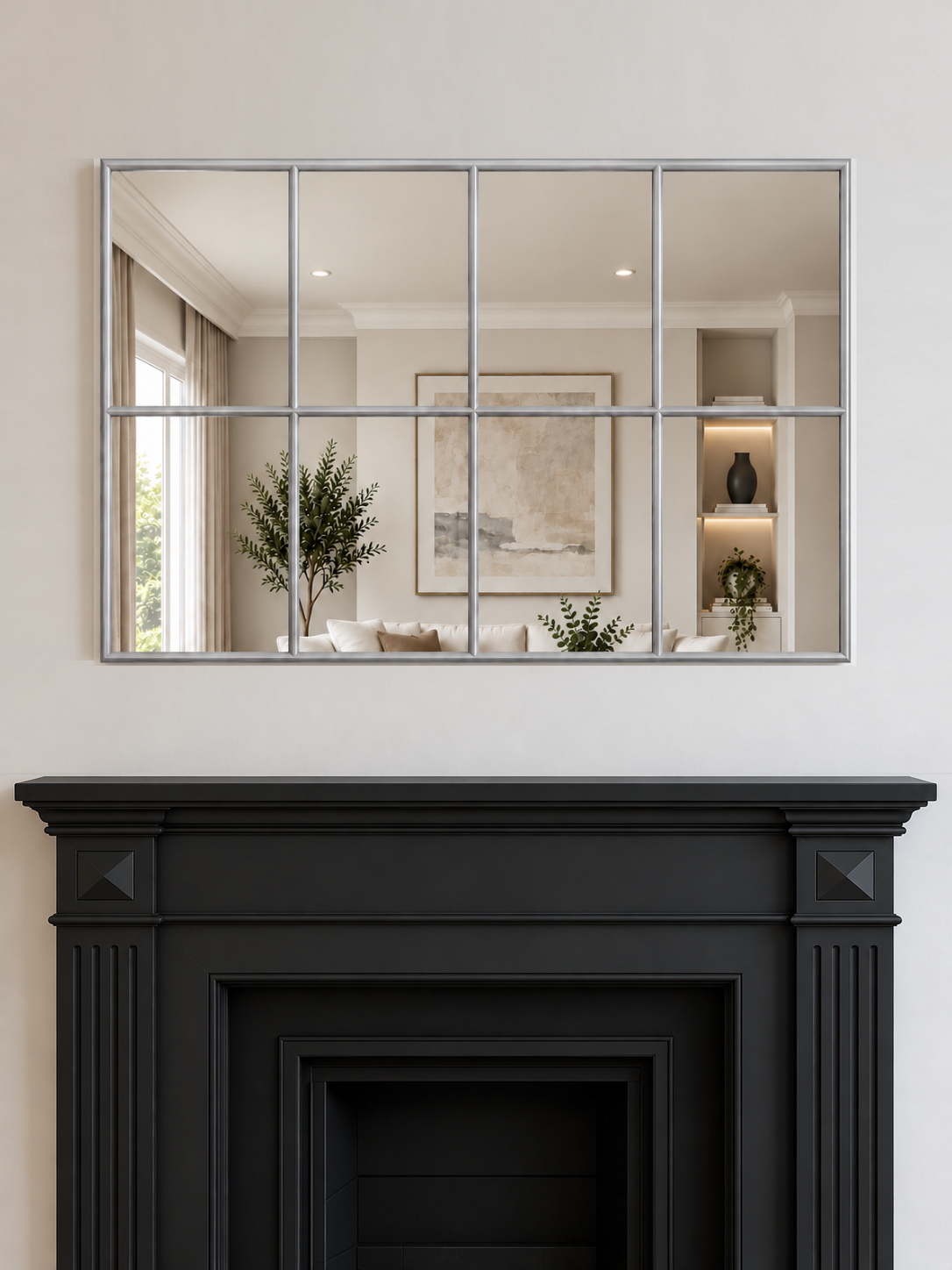 A large rectangular wall mirror with a silver metal grid frame hangs above a black fireplace 