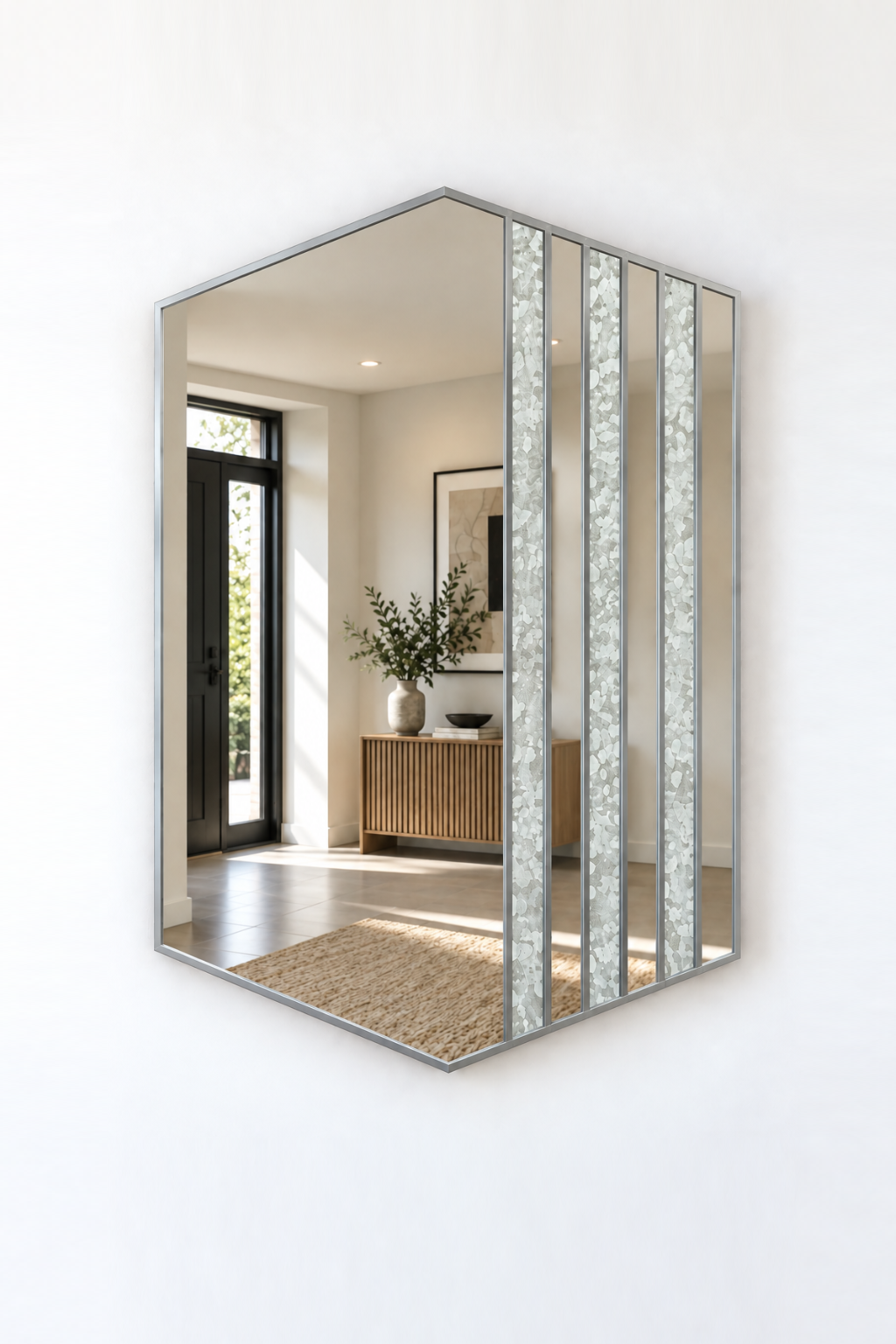 Hexagonal wall mirror with a silver metal frame and vertical textured glass panels, mounted on a white wall.