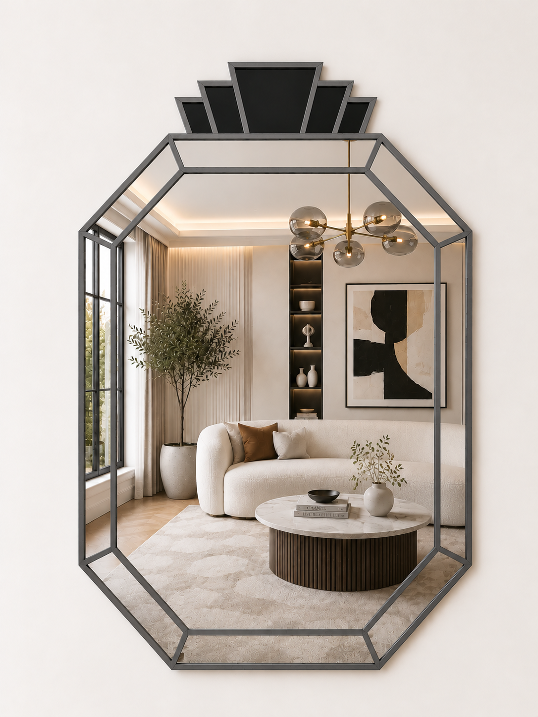 An octagonal wall mirror with a dark gray metal frame and a decorative black geometric top section, reflecting a modern living room interior with a cream sofa, round coffee table, and pendant lights.