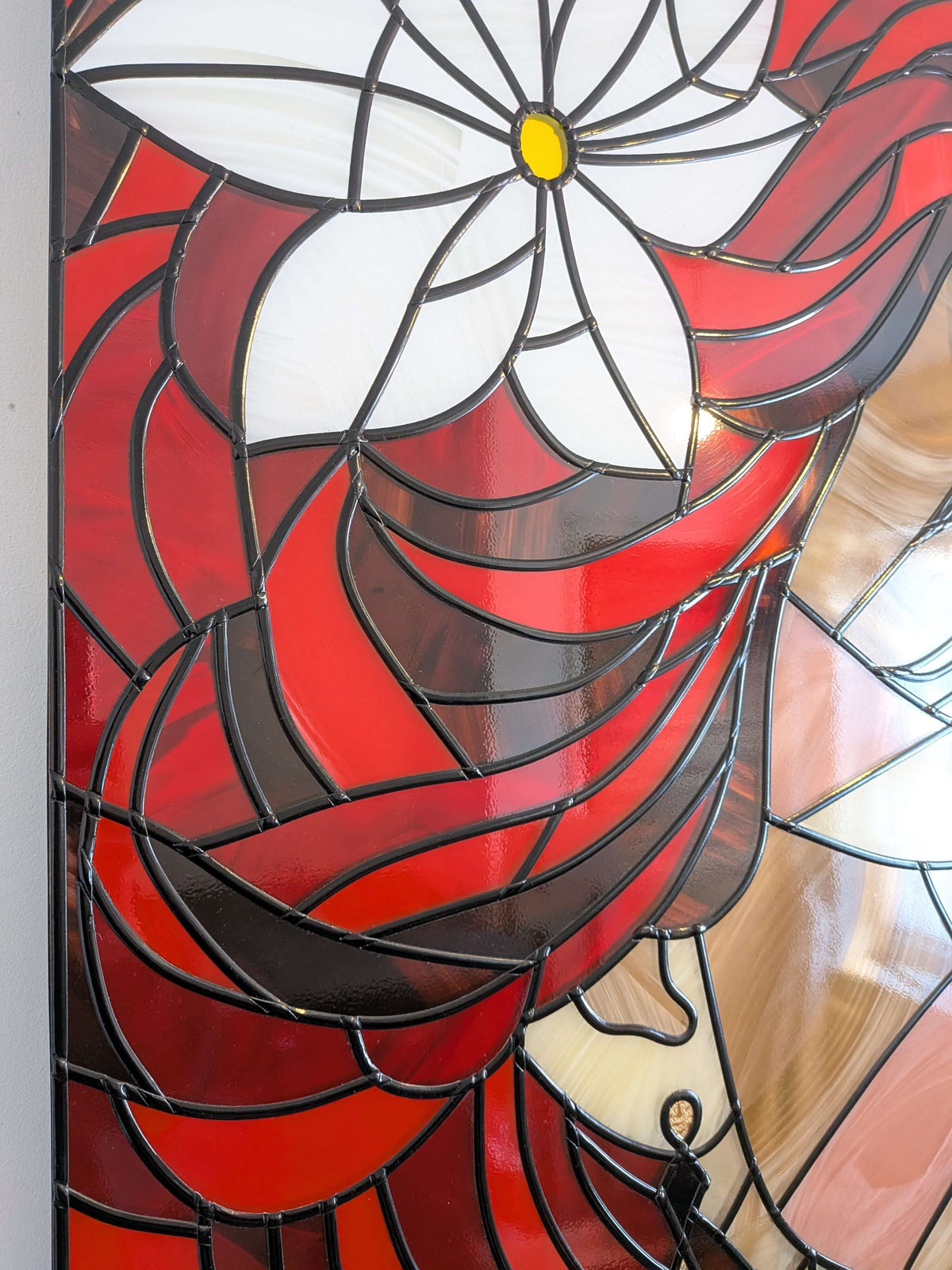 Stained glass panel with a red and white floral design