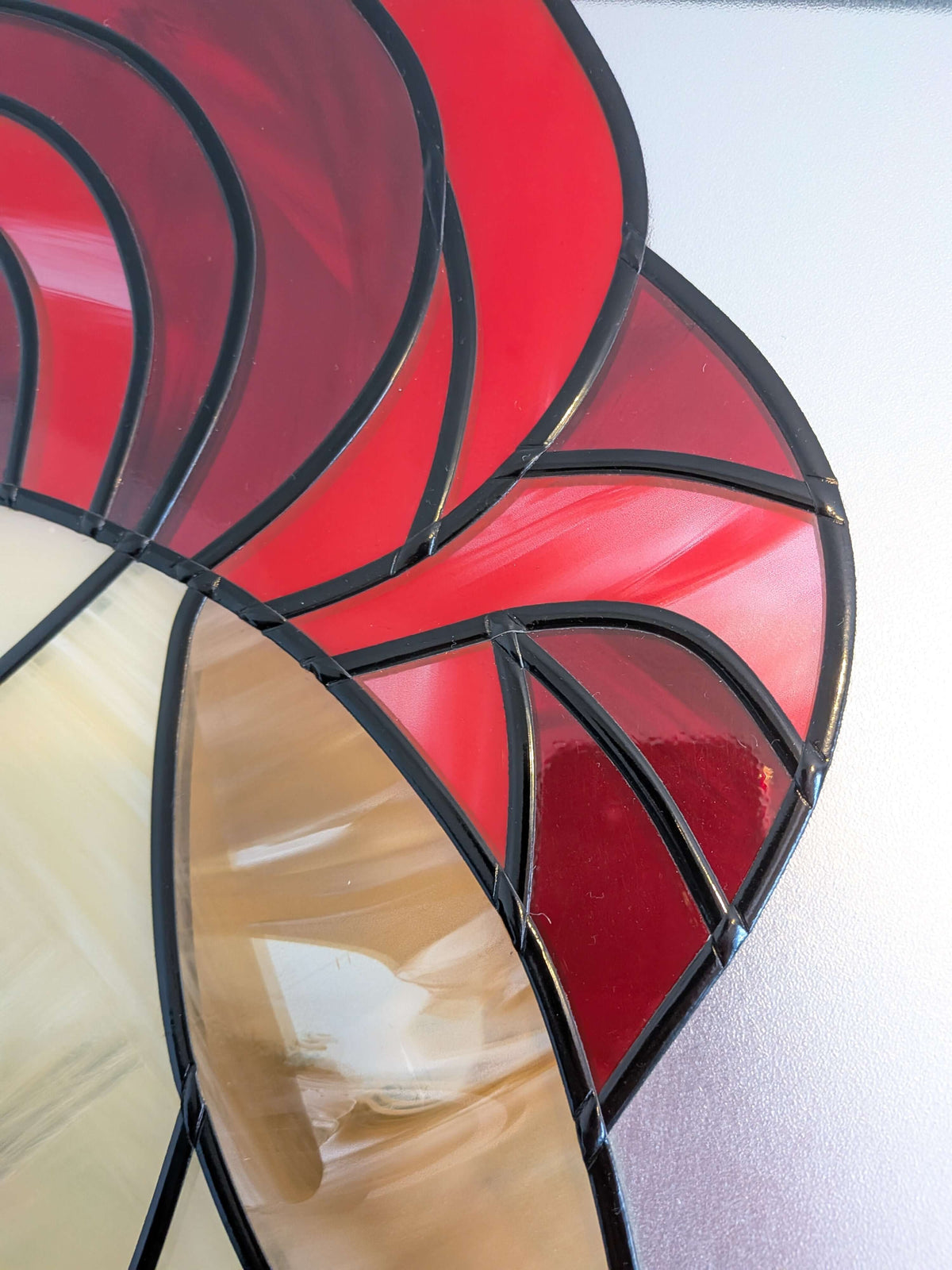 Close-up of a red and black stained glass panel