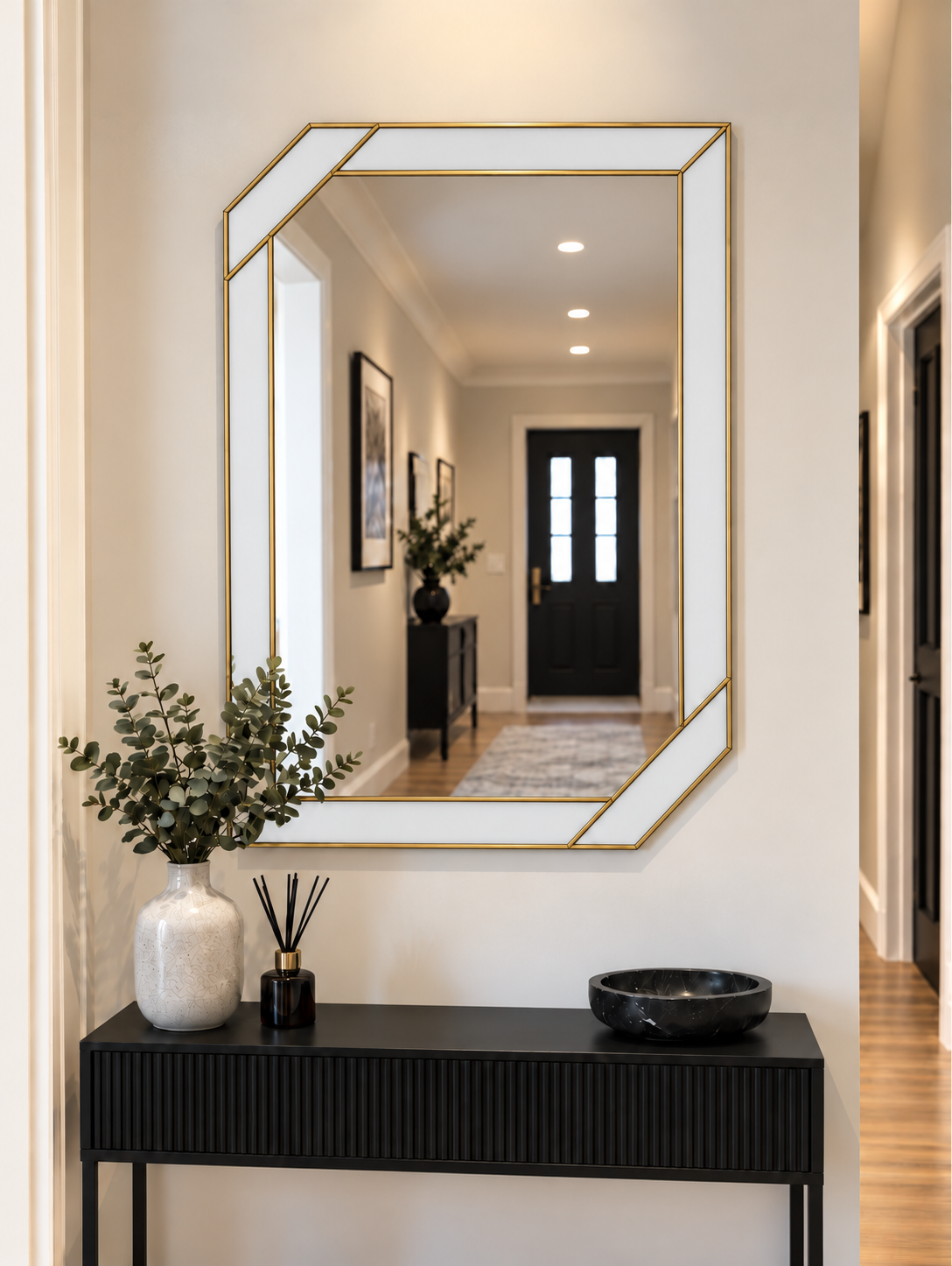 Art deco wall mirror featuring a white border style outer panels in brass